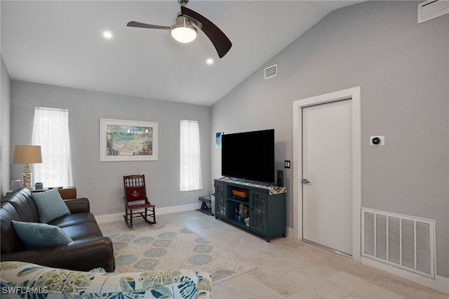 living room featuring ceiling fan, a healthy amount of sunlight, and vaulted ceiling