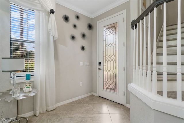 tiled entrance foyer featuring ornamental molding