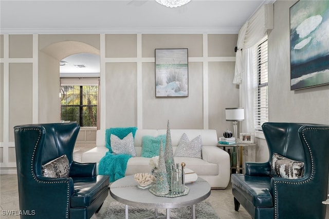 living area featuring a healthy amount of sunlight and ornamental molding