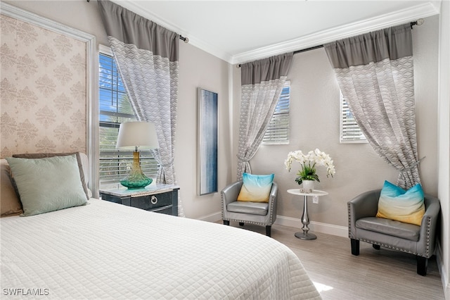 bedroom with hardwood / wood-style floors and crown molding