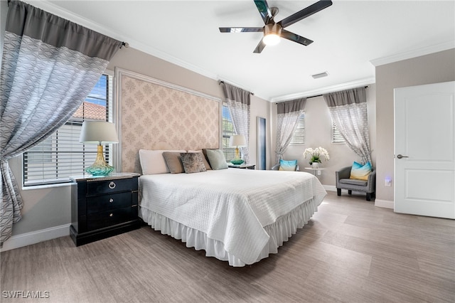 bedroom featuring wood-type flooring, ceiling fan, and ornamental molding