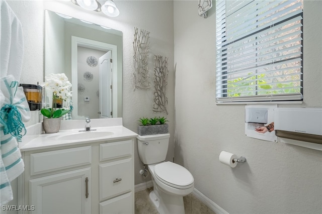 bathroom with tile patterned floors, vanity, and toilet