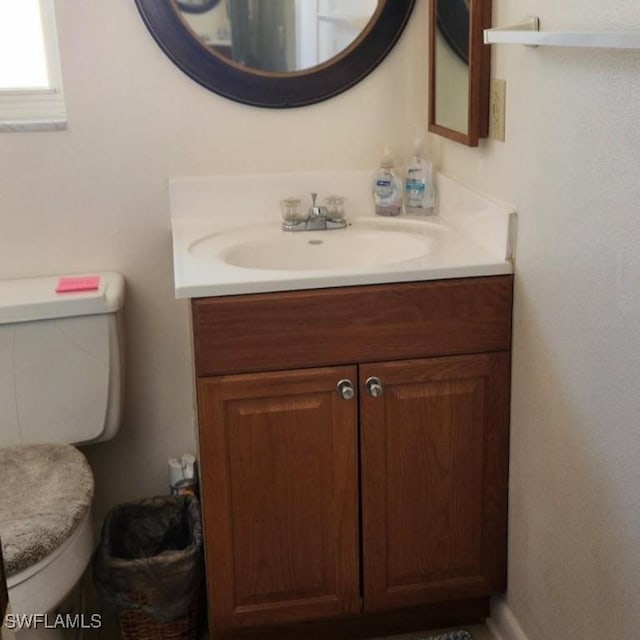 bathroom featuring vanity and toilet