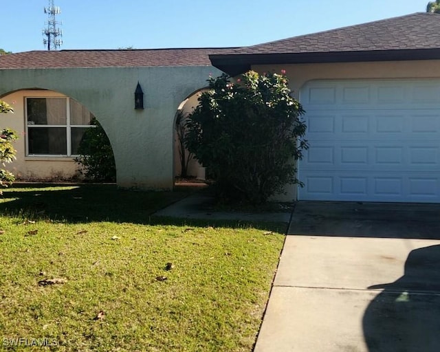 view of side of home with a garage and a lawn