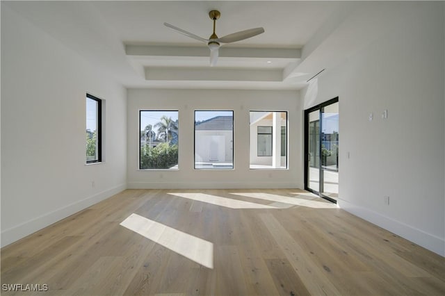 unfurnished room with beam ceiling, ceiling fan, and light wood-type flooring