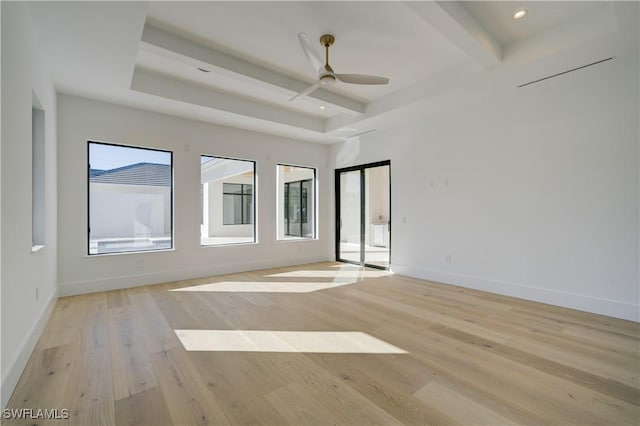 spare room with beam ceiling, ceiling fan, and light wood-type flooring