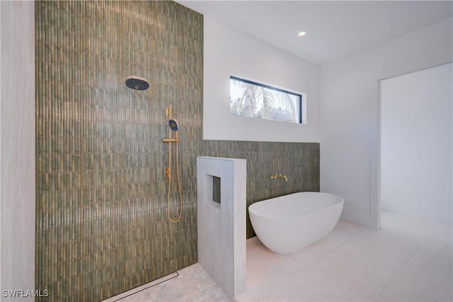 bathroom featuring shower with separate bathtub