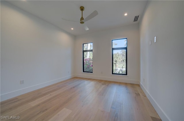 spare room with ceiling fan and light wood-type flooring