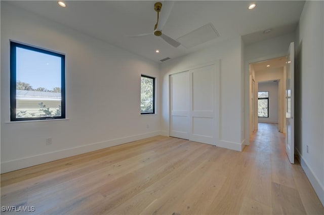 unfurnished bedroom featuring light hardwood / wood-style flooring, a closet, and ceiling fan