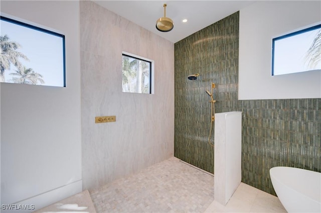 bathroom featuring tile patterned floors, separate shower and tub, and tile walls