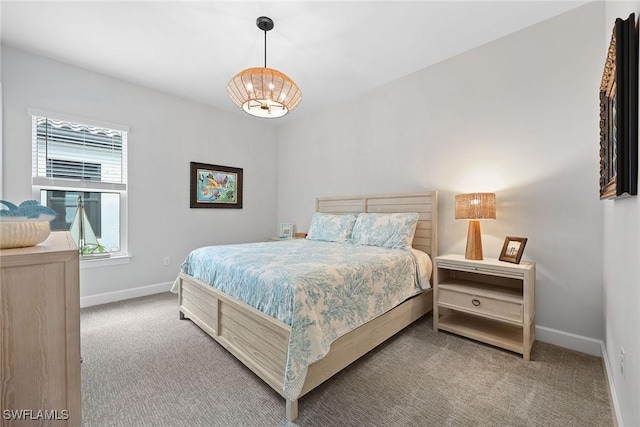 bedroom featuring carpet and a chandelier