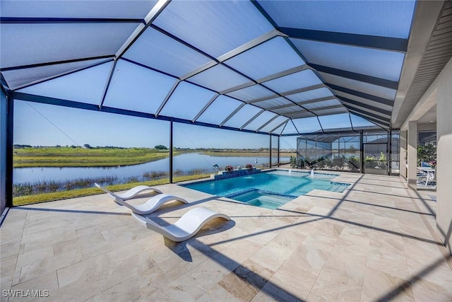 view of swimming pool with an in ground hot tub, pool water feature, a water view, glass enclosure, and a patio area