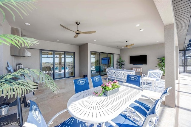 view of patio with an outdoor living space and ceiling fan