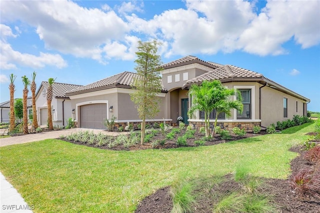 mediterranean / spanish house with a garage and a front yard