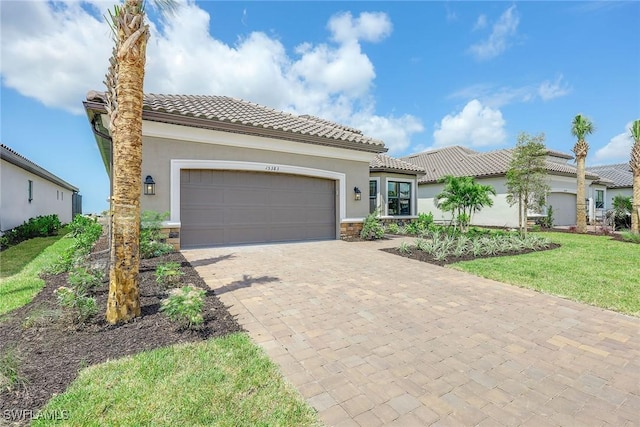 mediterranean / spanish house featuring a garage and a front yard