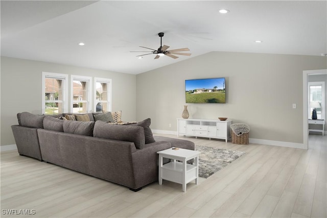 living room with light hardwood / wood-style floors, vaulted ceiling, and ceiling fan