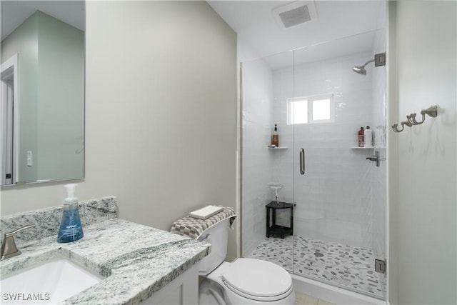 bathroom featuring vanity, an enclosed shower, and toilet