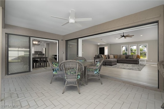 dining area featuring ceiling fan and light wood-type flooring