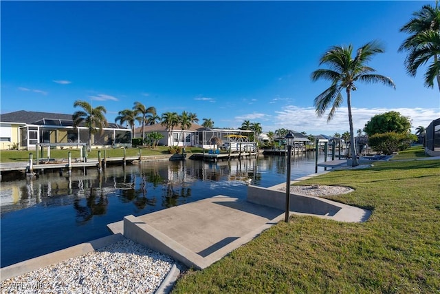 dock area with a yard and a water view