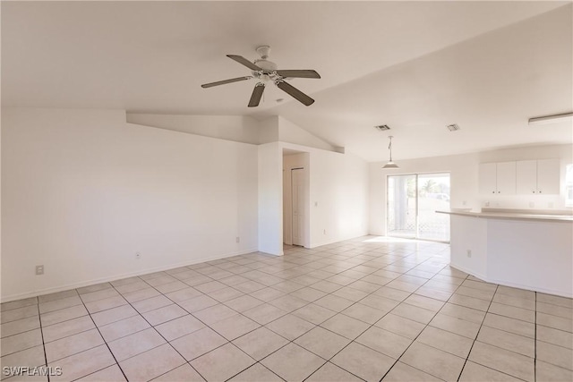 tiled empty room with ceiling fan and lofted ceiling