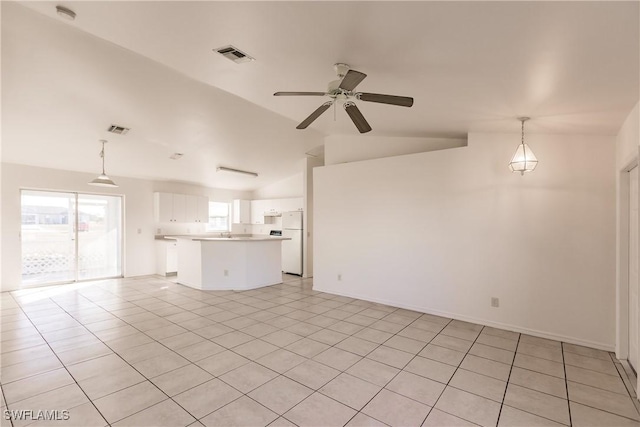 unfurnished living room featuring light tile patterned floors, vaulted ceiling, and ceiling fan