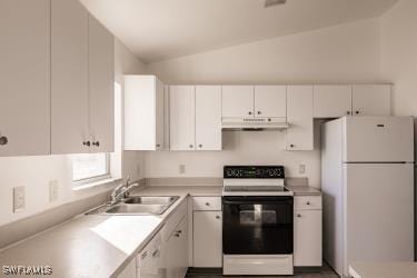 kitchen featuring white appliances, white cabinetry, vaulted ceiling, and sink