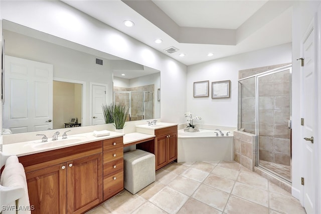 bathroom with tile patterned flooring, vanity, and shower with separate bathtub