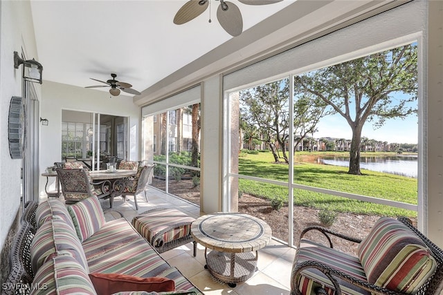 sunroom with a water view and ceiling fan