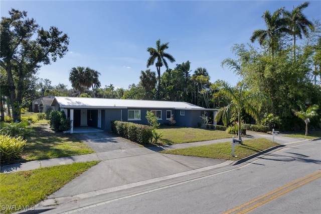 single story home with a carport and a front yard