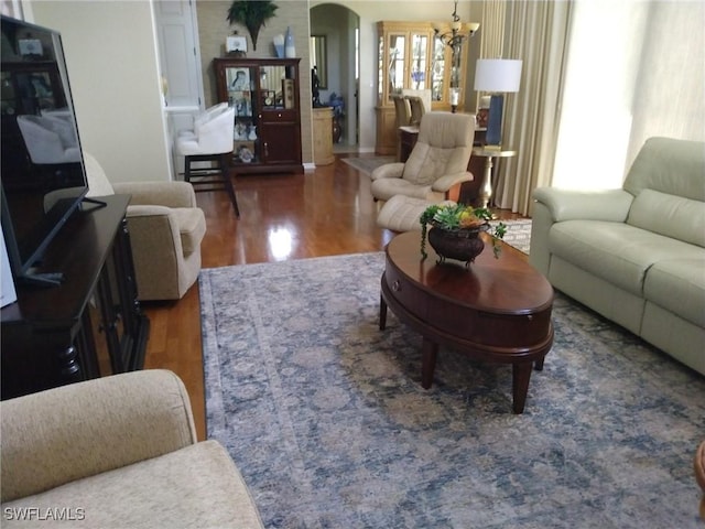 living room with hardwood / wood-style floors and an inviting chandelier