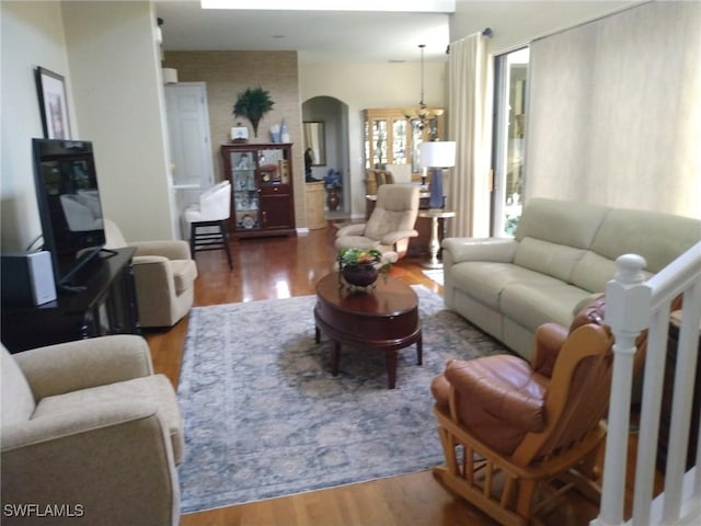 living room featuring hardwood / wood-style floors and a chandelier