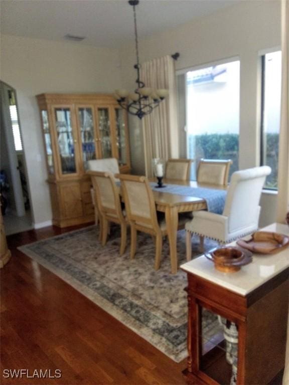 dining room with a notable chandelier and wood-type flooring