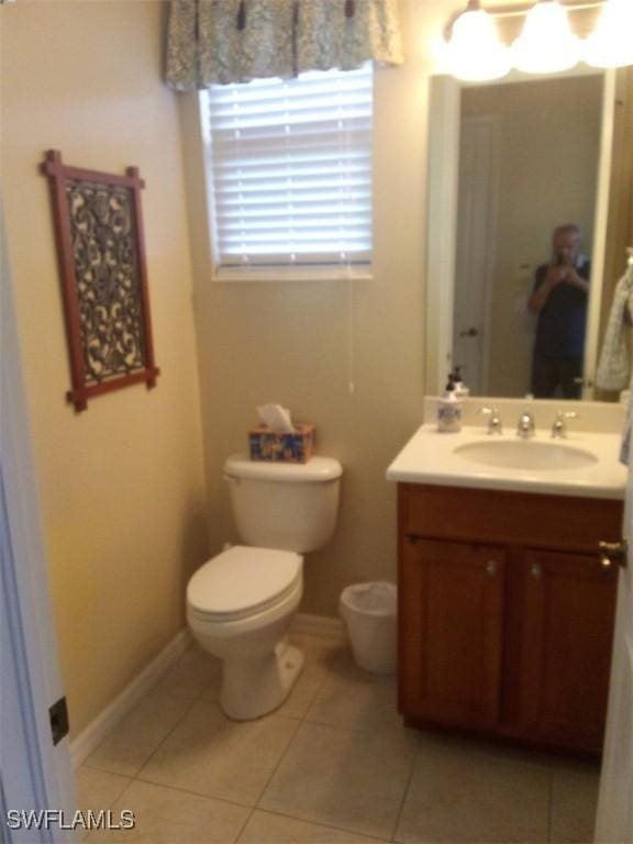 bathroom featuring tile patterned floors, vanity, and toilet