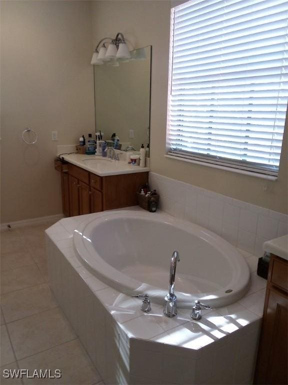 bathroom featuring vanity, tiled bath, and tile patterned floors