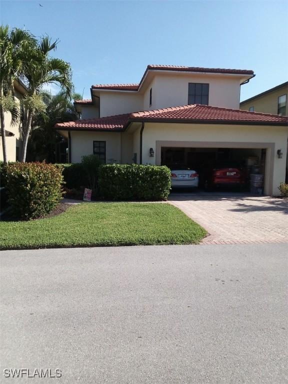 mediterranean / spanish-style home with a garage