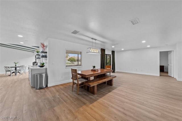 dining space featuring light wood-type flooring