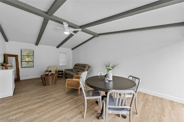 dining room featuring ceiling fan, light hardwood / wood-style floors, and vaulted ceiling with beams