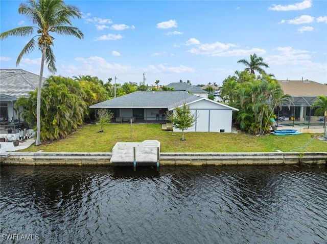 dock area with a water view and a lawn