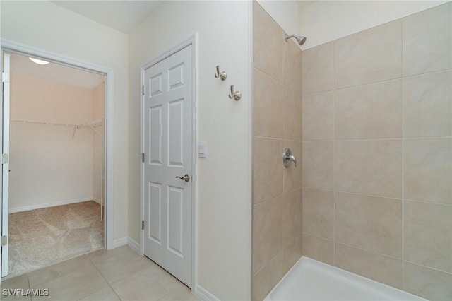 bathroom with tile patterned flooring and tiled shower