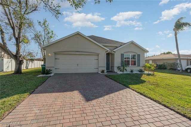 ranch-style house featuring a garage and a front lawn