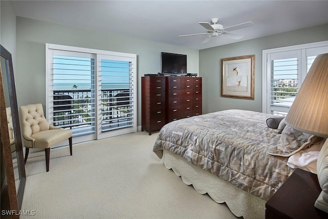 bedroom with access to outside, light colored carpet, and ceiling fan