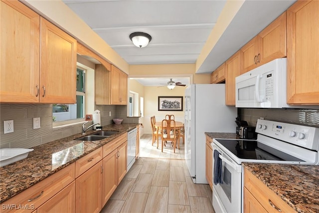 kitchen featuring backsplash, white appliances, ceiling fan, sink, and dark stone countertops