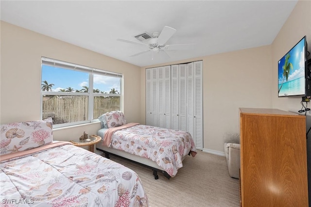 bedroom with light carpet, a closet, and ceiling fan