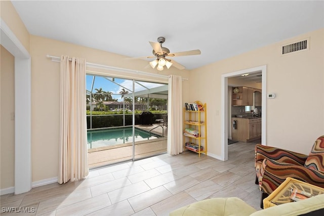 doorway featuring ceiling fan