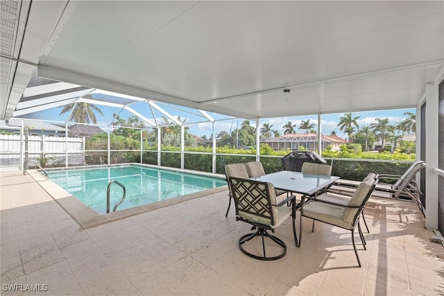 view of swimming pool with glass enclosure and a patio area