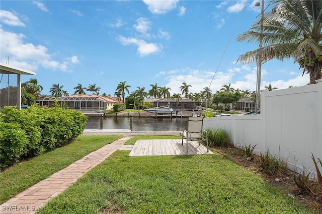 view of yard with a boat dock and a water view