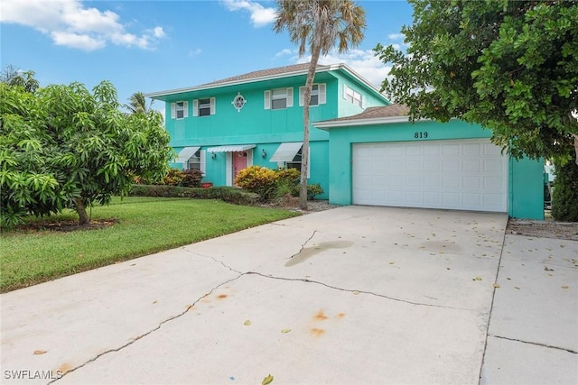 view of front of house featuring a garage and a front yard