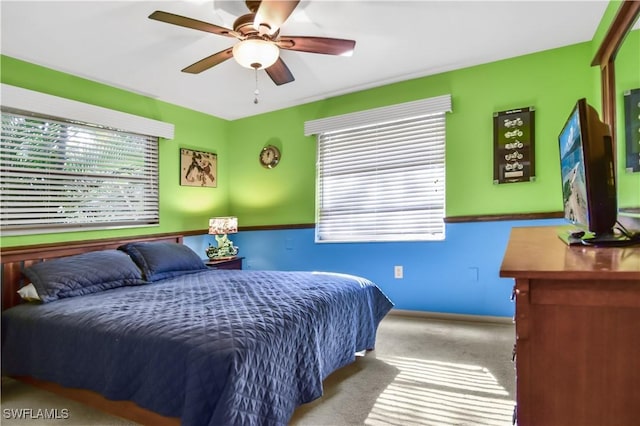 bedroom with ceiling fan and light carpet