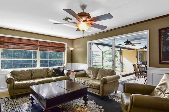 living room featuring ceiling fan and ornamental molding