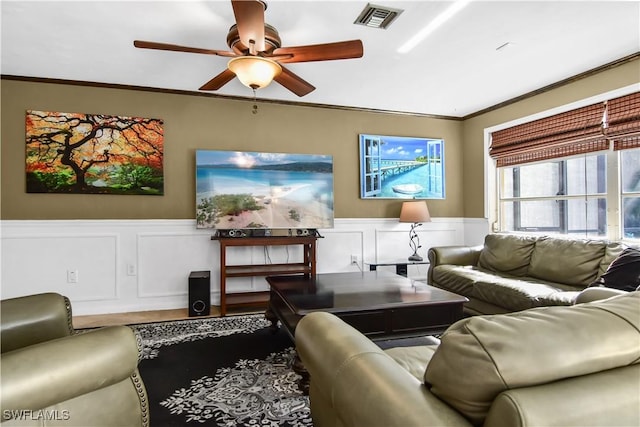 living room with ceiling fan and crown molding